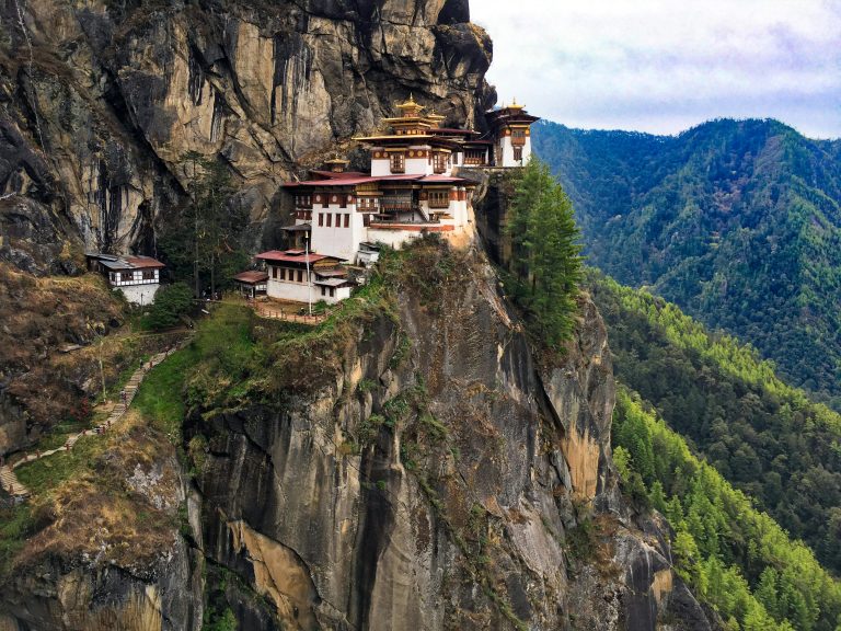 A breathtaking view of the iconic Tiger's Nest Monastery perched on a cliff in Bhutan's lush landscape.